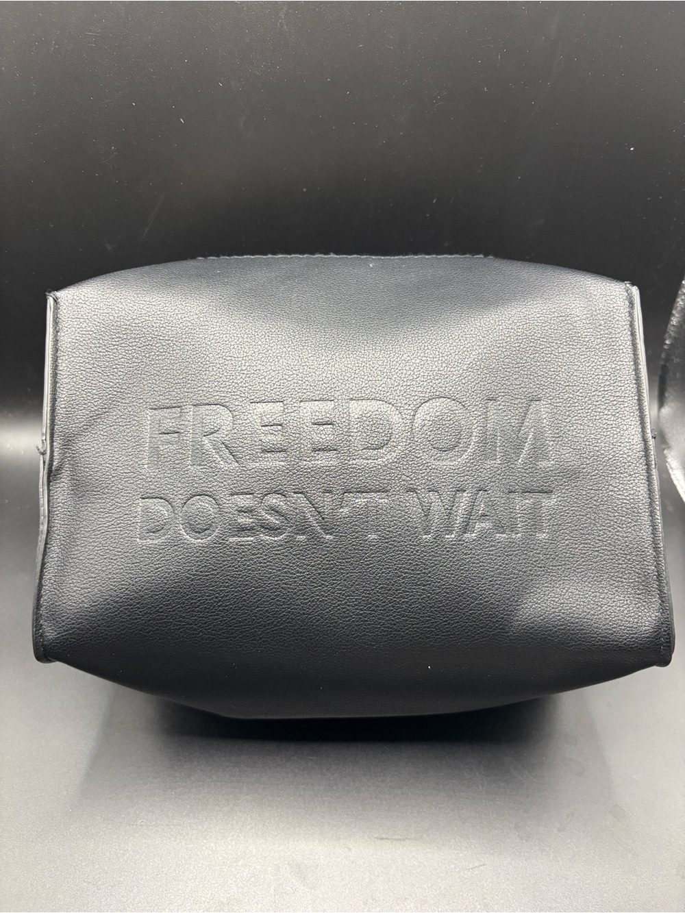 Yves Saint Laurent Black Embossed Freedom Slogan Toiletry Bag